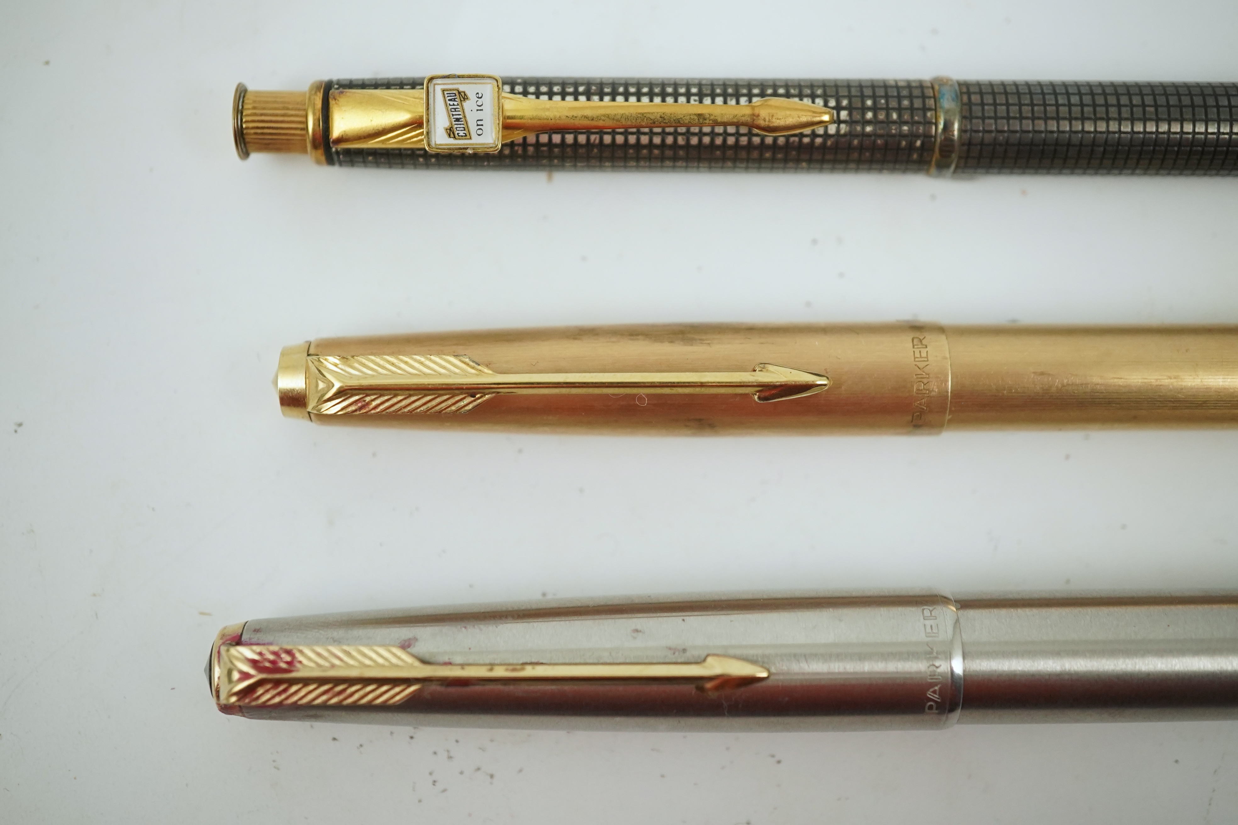 A Cross advertising propelling pencil, Cointreau on ice, a Parker felt tip cartridge pen and a cased Parker stainless steel pen. Condition - poor to fair